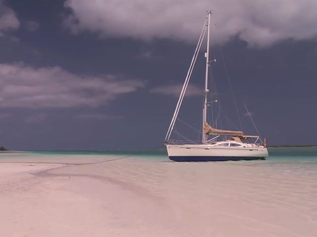 A sailboat anchored off the San Blas islands A sailboat anchored off the San Blas islands